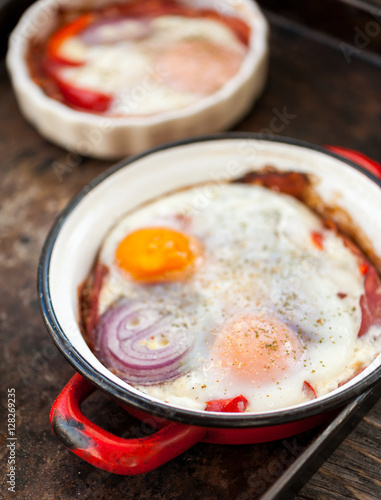 Baked eggs with bacon, red pepper  and onion