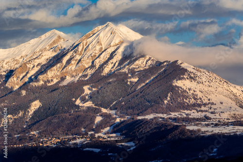 Sunset on the Petite and Grande Autane mountain peaks with view on Saint Leger Les Melezes. Champsaur, Hautes Alpes, Southern French Alps, France photo