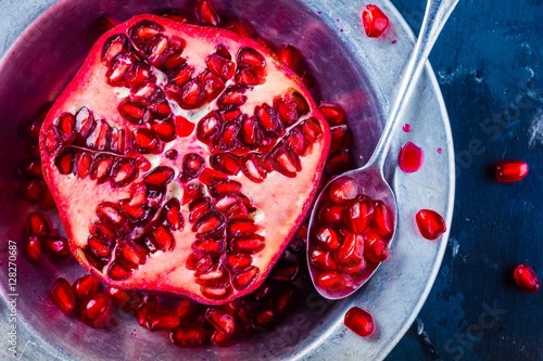 bright juicy ripe pomegranate with seeds in a bowl