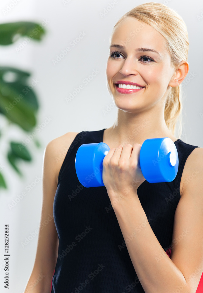 woman doing exercise with dumbbell