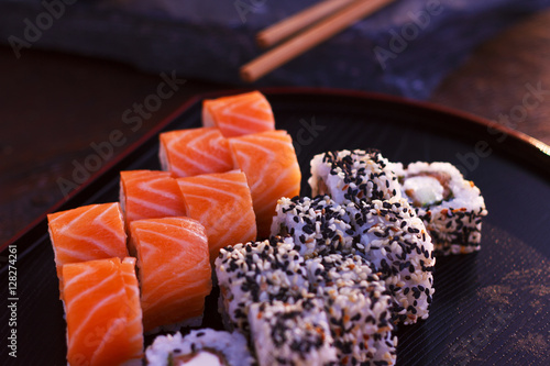 Japanese sushi rolls filadelfia on black stone outdoor