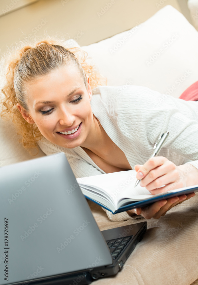 woman working with organizer and laptop, at home woman working with organizer and laptop, at home