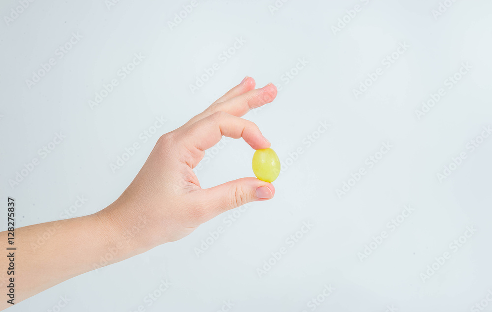 Grapes in a woman's hand on a white background Grapes in a woman's hand on a white background