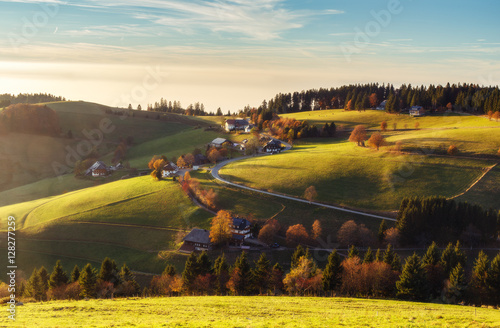Scenic autumn mountain landscape in autumn at sunset. View over a traditional village in Germany, Black Forest.