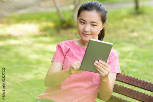 Woman use tablet in the garden