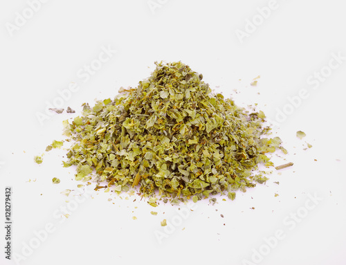 Spilled dried majoram heap isolated on white background