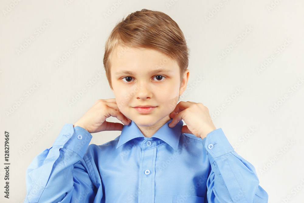 Little cute boy fastened collar of bright shirt Little cute boy fastened collar of bright shirt