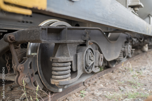 Close-ups Steel diesel railcar train bogie wheels on the tracks.