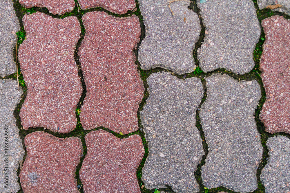 Fotografie Red and grey cement block on sidewalk