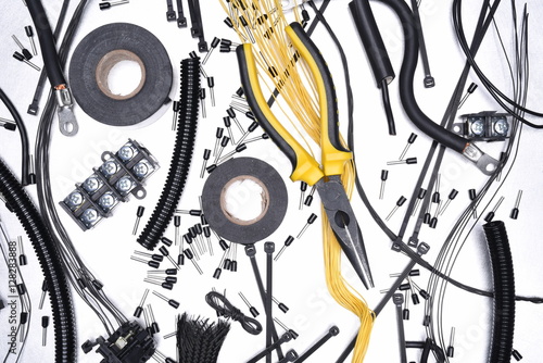 Electrical Accessories and Tool on Metal Background Top View