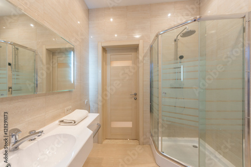 Bright bathroom interior with glass shower