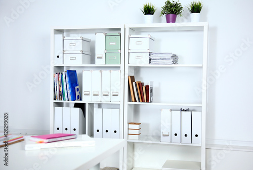 File folders, standing on the shelves at office.