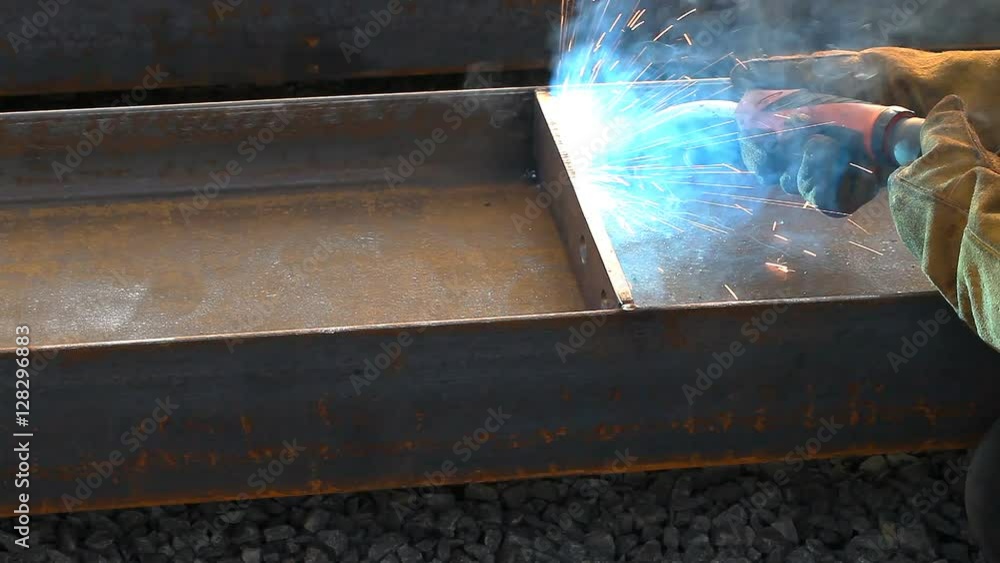 Worker welding in a factory. Welding on an industrial plant. Worker welding in a factory. Welding on an industrial plant.