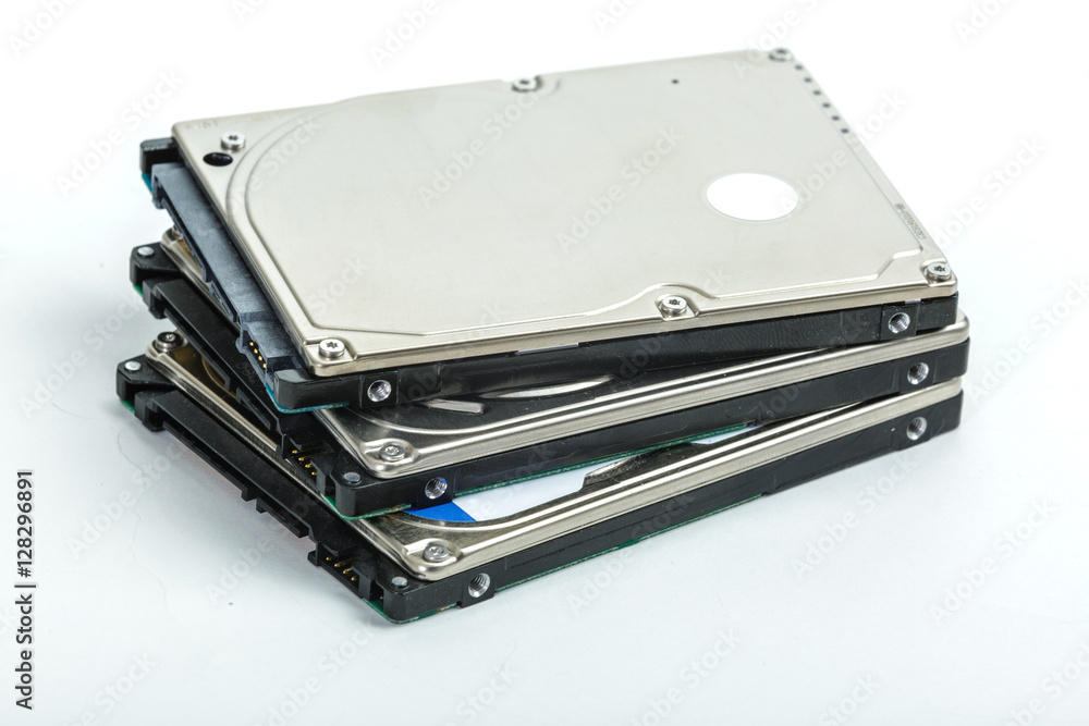 Three 2.5 inch laptop hard disk drives lie on each other. Isolated on white background. Three 2.5 inch laptop hard disk drives lie on each other. Isolated on white background.