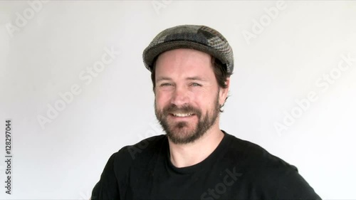 Model released man in studio wearing Scottish cap, smiling and gesturing.