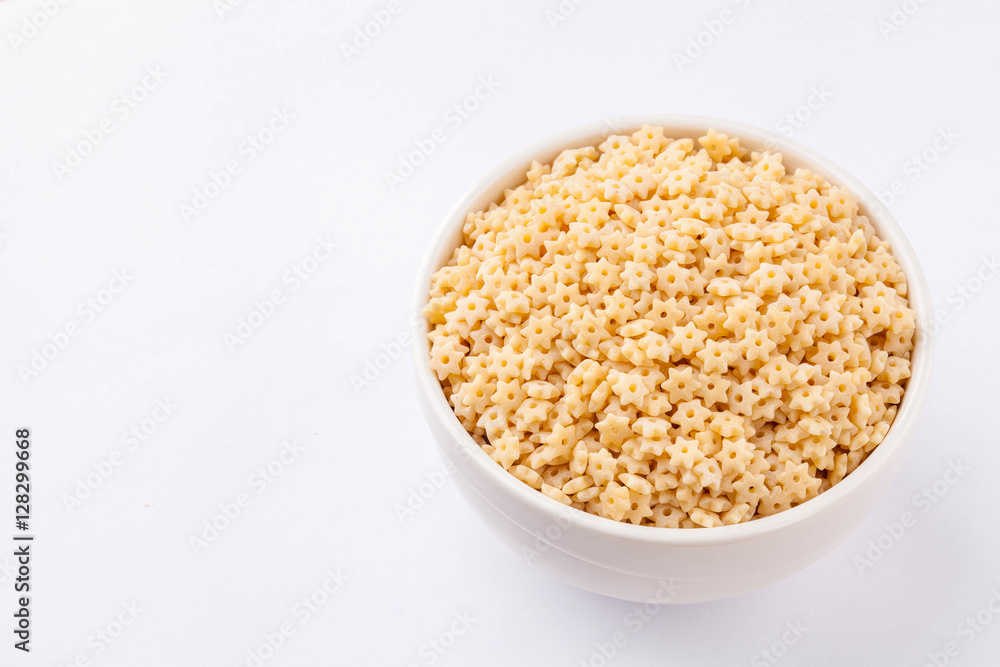 raw pasta in a white bowl raw pasta in a white bowl