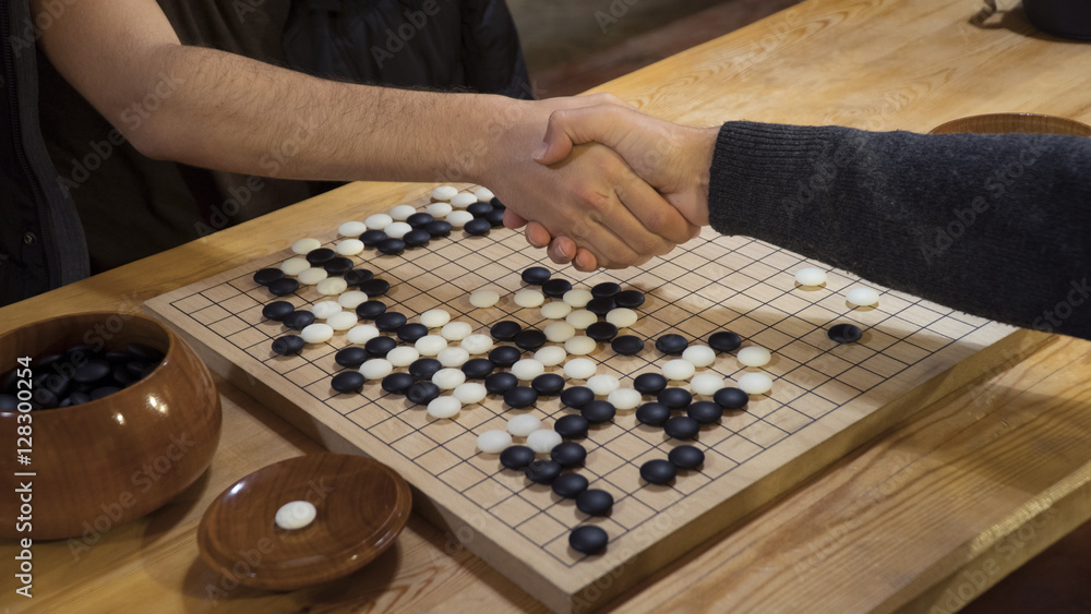 Hand shake before play Chinese board game Go or Weiqi Hand shake before play Chinese board game Go or Weiqi