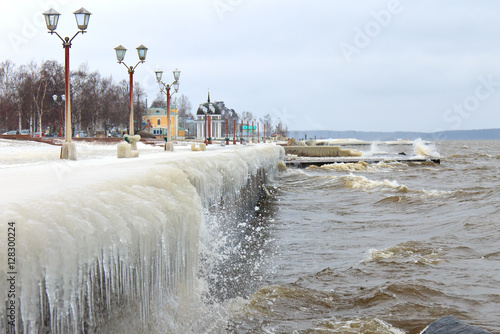 Winter storm on the lake and ice-covered city embankment. Onegalake, Petrozavodsk, Russia photo