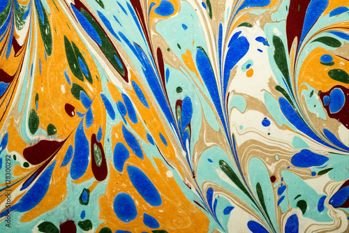 Ebru art. Traditional Turkish Ebru technique. Painting on water, followed by paper prints. Color paint ebru with waves and tile pattern.