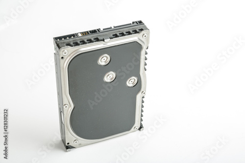 Black and silver desktop 3.5 inch hard disk. The disc has a vertical position, SATA connector upwards. Isolated on white background.