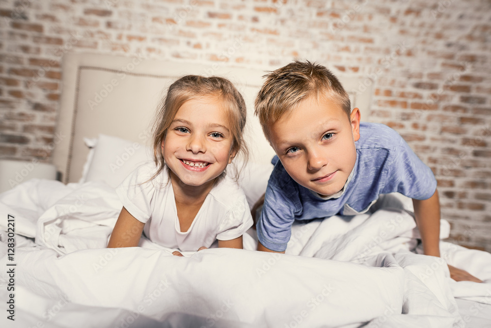 Brother and sister lying in bedroom together Brother and sister lying in bedroom together