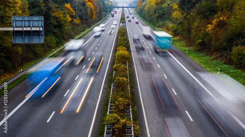 Autobahn mit Autos und LKW im Herbst photo