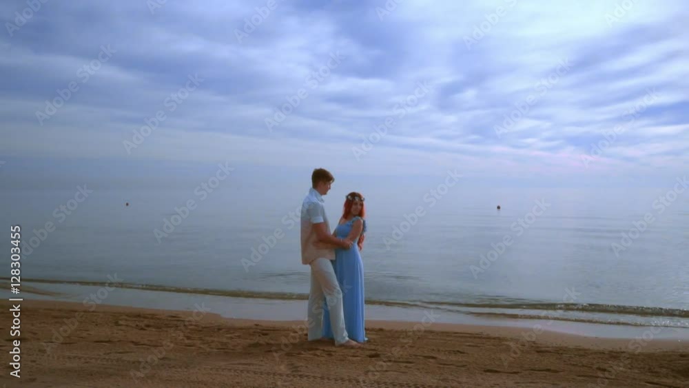 Pregnant couple beach. Pregnant couple hugging on sea beach. Couple expecting baby. Love couple beach. Pregnant woman with husband on beach. Pregnancy concept. Romantic vacation on beach Pregnant couple beach. Pregnant couple hugging on sea beach. Couple expecting baby. Love couple beach. Pregnant woman with husband on beach. Pregnancy concept. Romantic vacation on beach