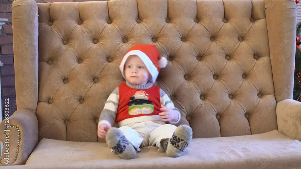 Little Boy on Sofa near Christmas Tree. 4K Little Boy on Sofa near Christmas Tree. 4K