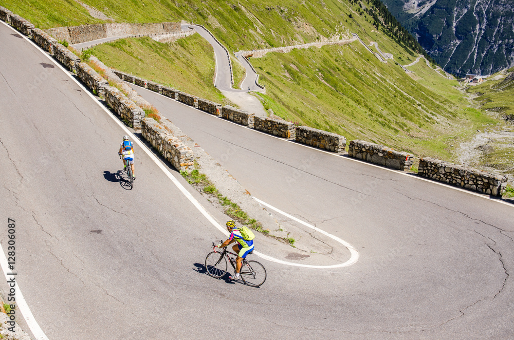 Naklejka premium Man ride on bicycle from Famous Passo Dello Stelvio Climb. Italian - Swiss border, Alpen. Original sport wallpaper