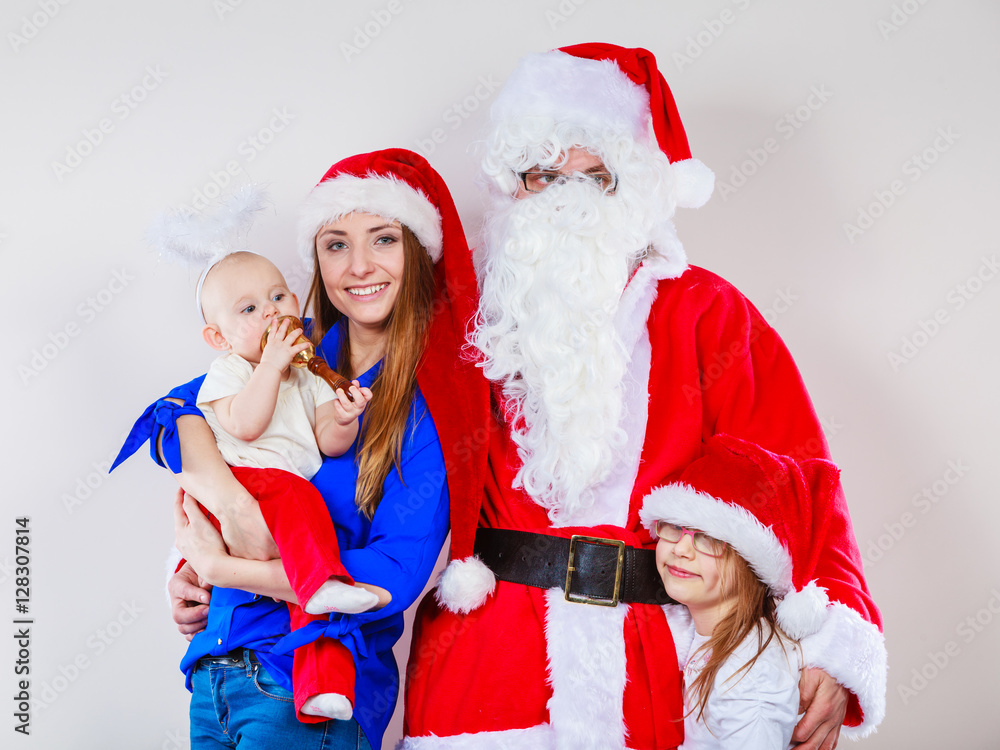 Fototapeta premium Mother, Santa and two daughters christmas family photo