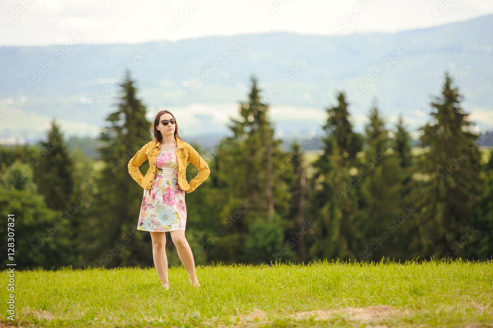 Obraz premium Brunette girl enjoying journey in mountains.
