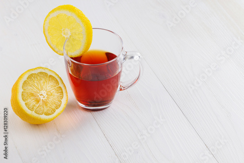 Glass cup of hot tea and a lemon