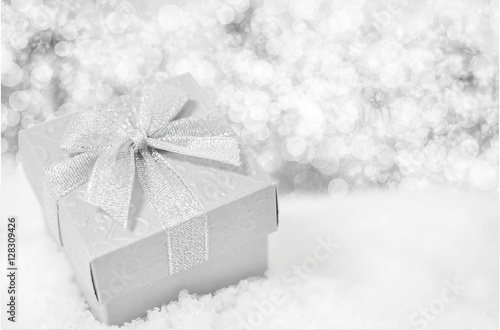 Christmas background - Close up of silver gift box with ribbon b