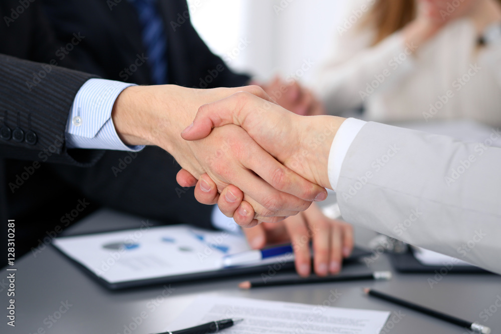 Close up of two business man shaking hands to each other finishing up the meeting Close up of two business man shaking hands to each other finishing up the meeting