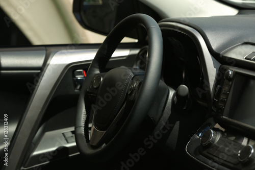 Steering wheel in car interior © Africa Studio