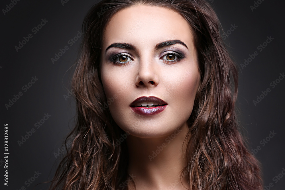 Portrait of beautiful young woman model with bright makeup on dark background Portrait of beautiful young woman model with bright makeup on dark background