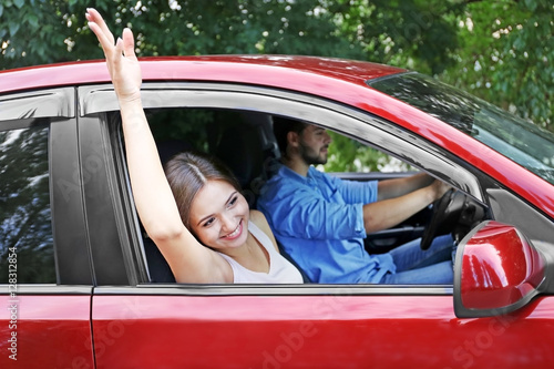 Pretty young woman waving t...