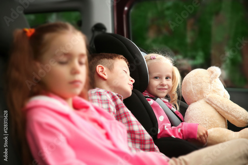Cute children sleeping in a car