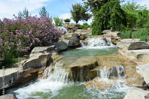 Watery fountain and manmade falls in a public garden and park