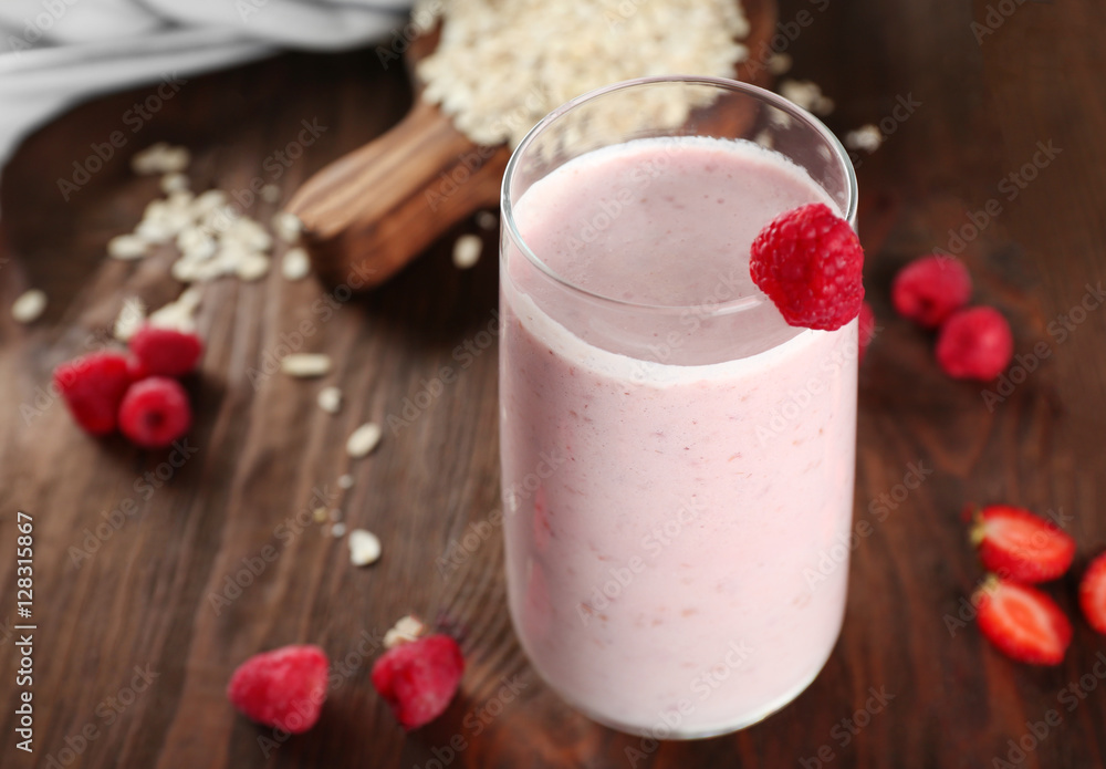 Fresh milkshake with berries and oatmeal on wooden background Fresh milkshake with berries and oatmeal on wooden background