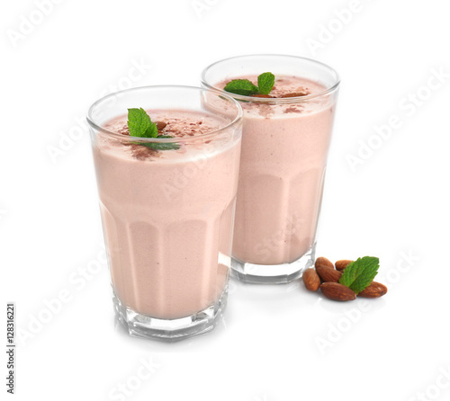 Glasses with delicious nut milk shake isolated on white