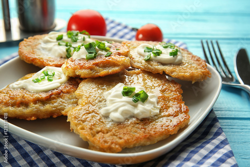 Plate with tasty potato pancakes for Hanukkah on wooden table, closeup