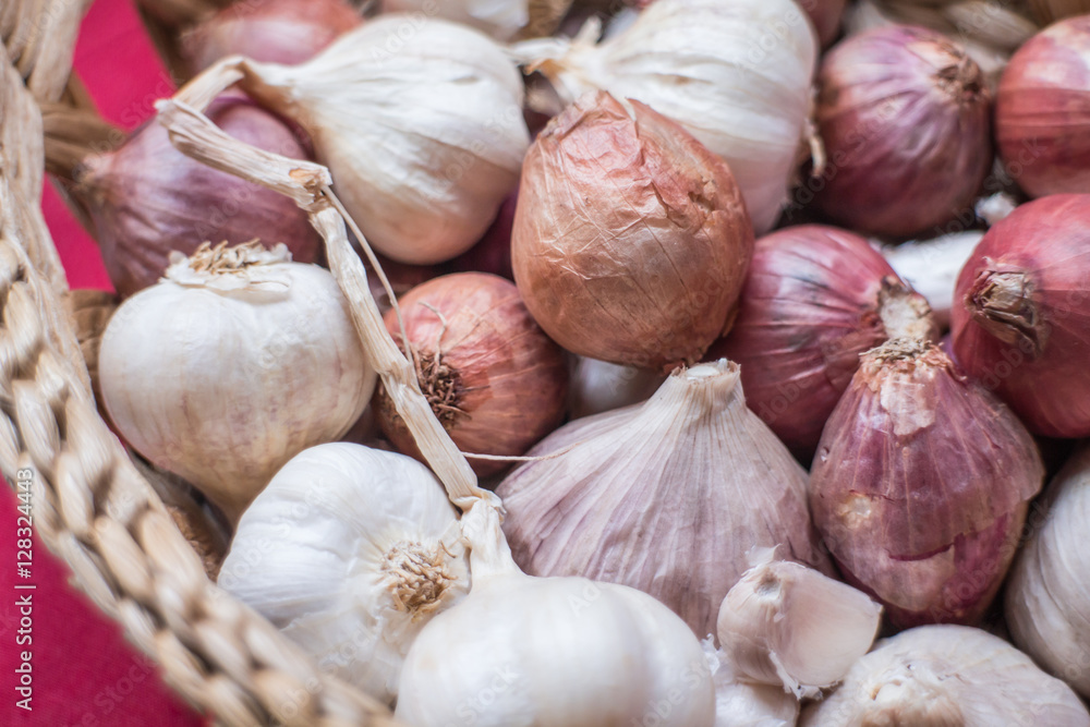 Close-up fresh shallots and garlics in the basket