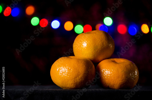 Christmas tangerine or mandarin on a garland background