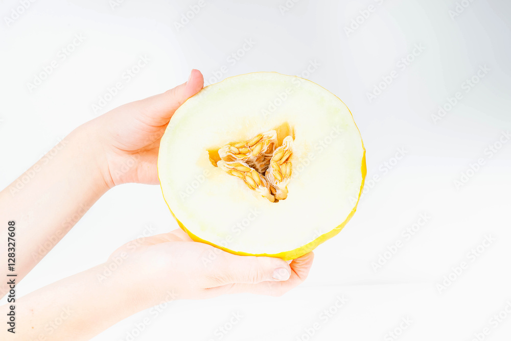 cut melon in the hands of women on a white background cut melon in the hands of women on a white background