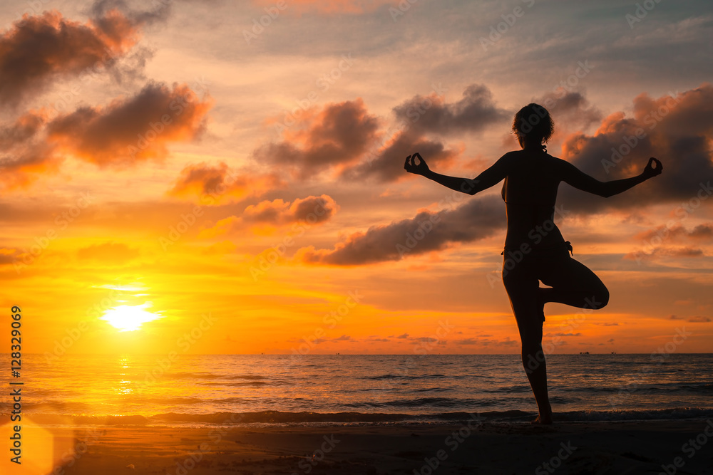 Yoga practicing at sunset, serenity and meditation.