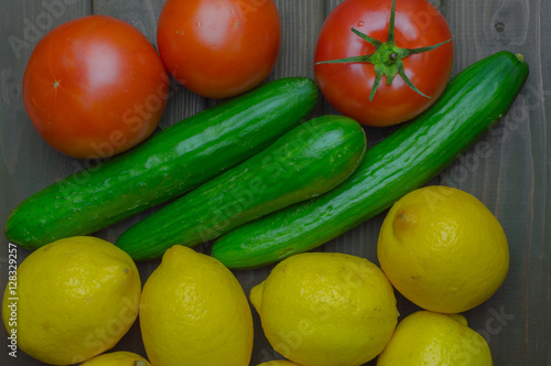 Fresh vegetables and fruits top view on dark wooden background.