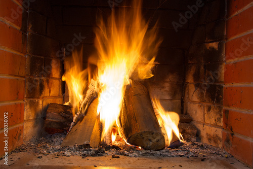 Fire in fireplace. Fire background. Blazing Bonfire. Firewood burns in a fireplace.