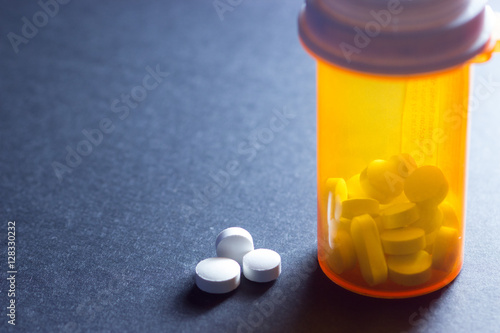 Pills next to pill bottle