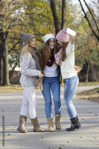 Three girls in the park taking selfie